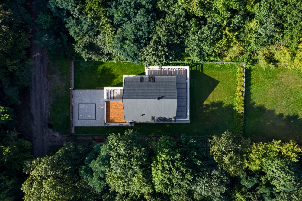 Aerial view of a home with a privacy fence around the property built and designed by Brick Experts DFW